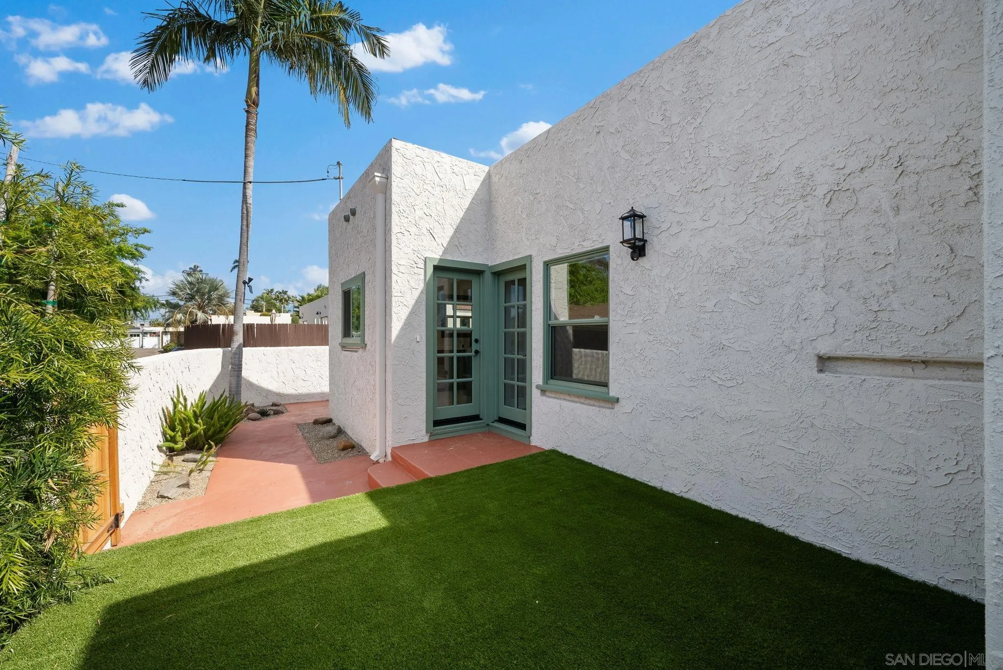 4052 Alder Drive San Diego, CA 92116 - Photo 26 of 28 a front view of a house with a yard and potted plants