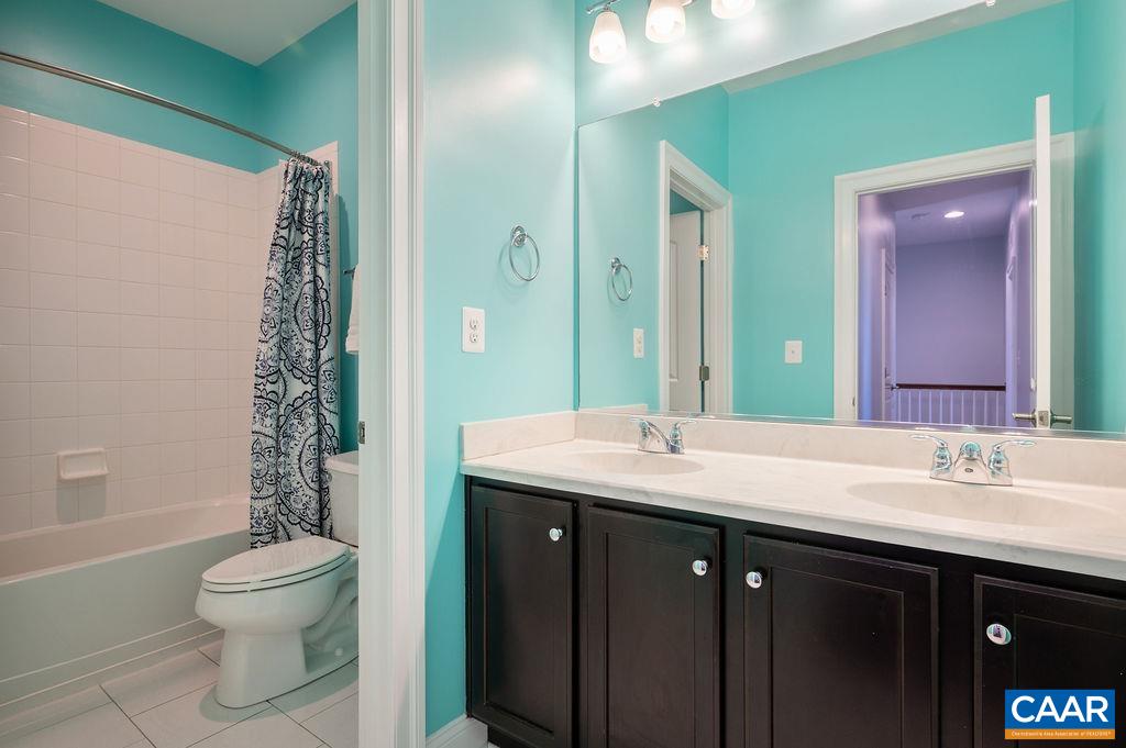 2146 Avinity Loop Charlottesville, VA 22902 - Photo 15 of 27 a bathroom with a granite countertop sink toilet a large mirror and shower
