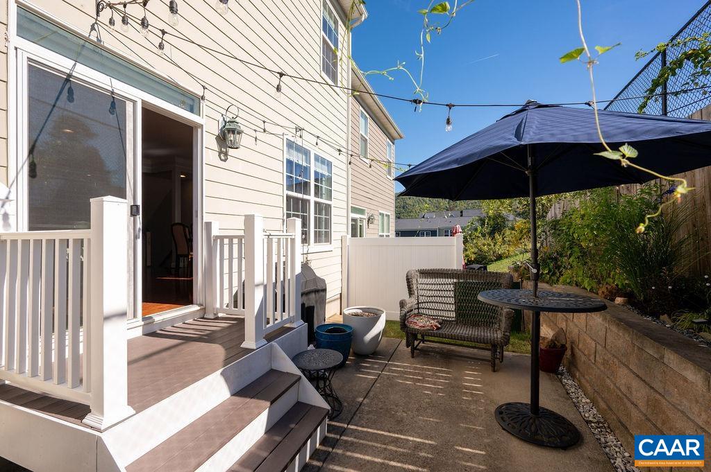 2146 Avinity Loop Charlottesville, VA 22902 - Photo 6 of 27 a view of a patio with a table and chairs under an umbrella
