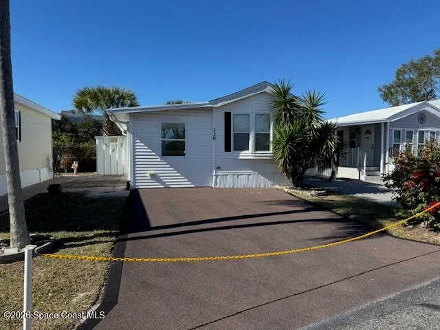 a house view with a sitting space and garden