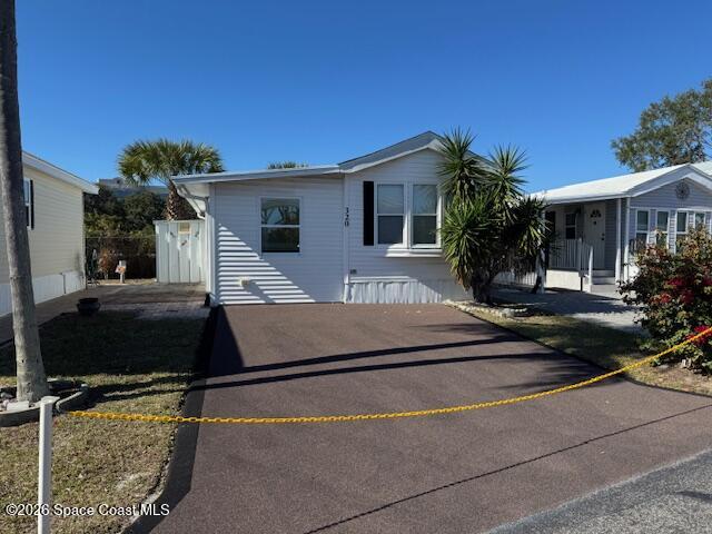 a house view with a sitting space and garden