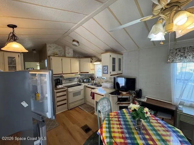 a kitchen with sink refrigerator and stove