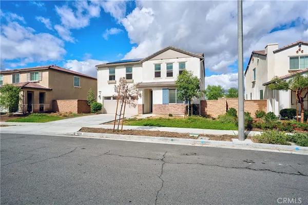 a front view of a house with a yard and a garage