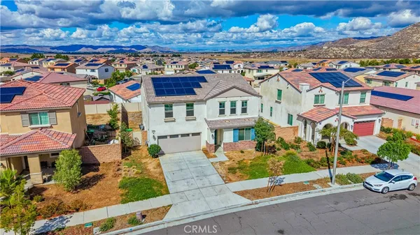 a view of a brick house with a fountain in front of it