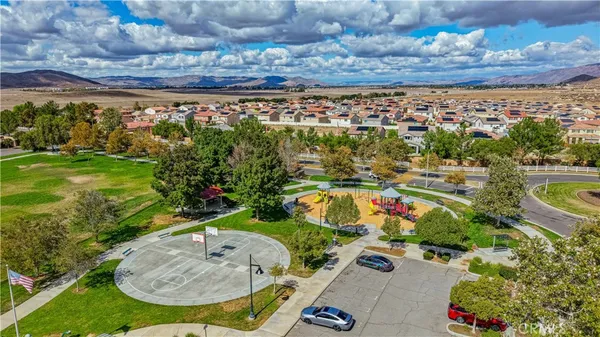 an aerial view of ocean and residential houses with outdoor space