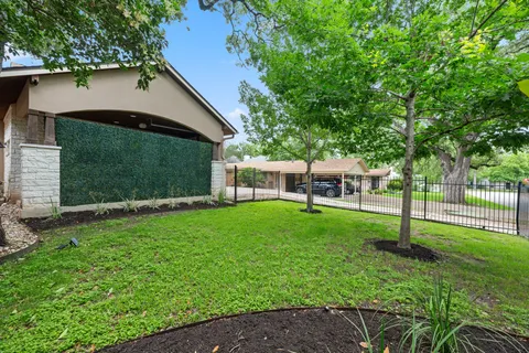 a view of a house with a yard and sitting area