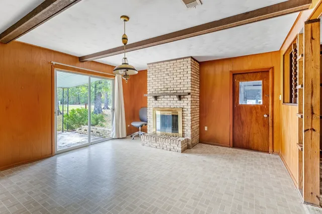 a view of an empty room with a fireplace