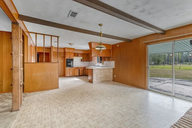 a kitchen with cabinets a sink and a window