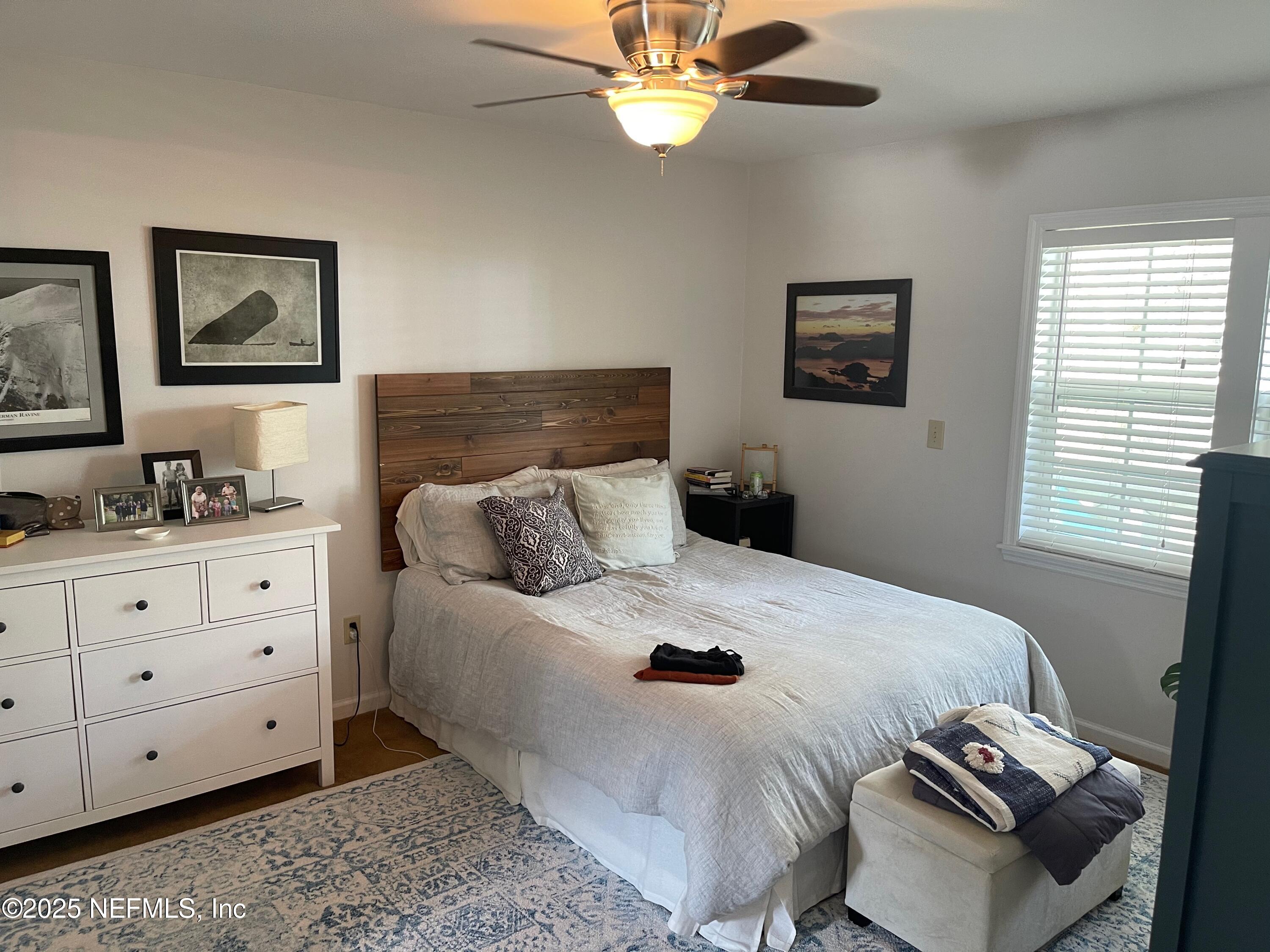 310 7th Street Atlantic Beach, FL 32233 - Photo 7 of 16 a bedroom with a bed and wooden floor