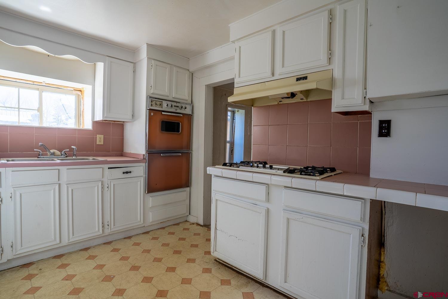 120 Browning Avenue Ignacio, CO 81137 - Photo 4 of 36 a kitchen with granite countertop white cabinets and stainless steel appliances