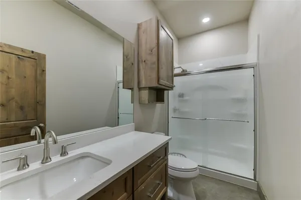 a bathroom with a sink toilet and shower