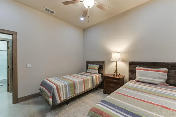 a bedroom with two beds and a chandelier