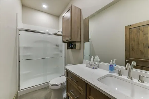 a bathroom with a sink toilet and shower