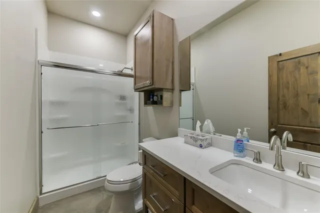 a bathroom with a sink toilet and shower