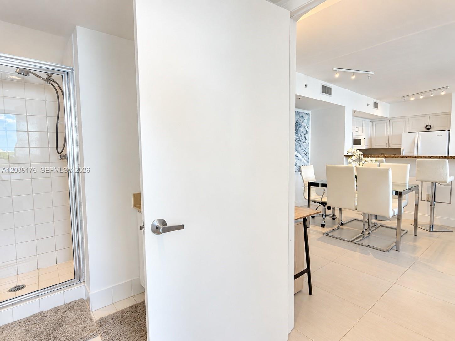 90 Alton Road, Unit 1710 Miami Beach, FL 33139 - Photo 15 of 16 Guest bathroom design with glass shower door access