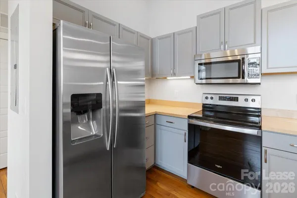 a kitchen with refrigerator and window