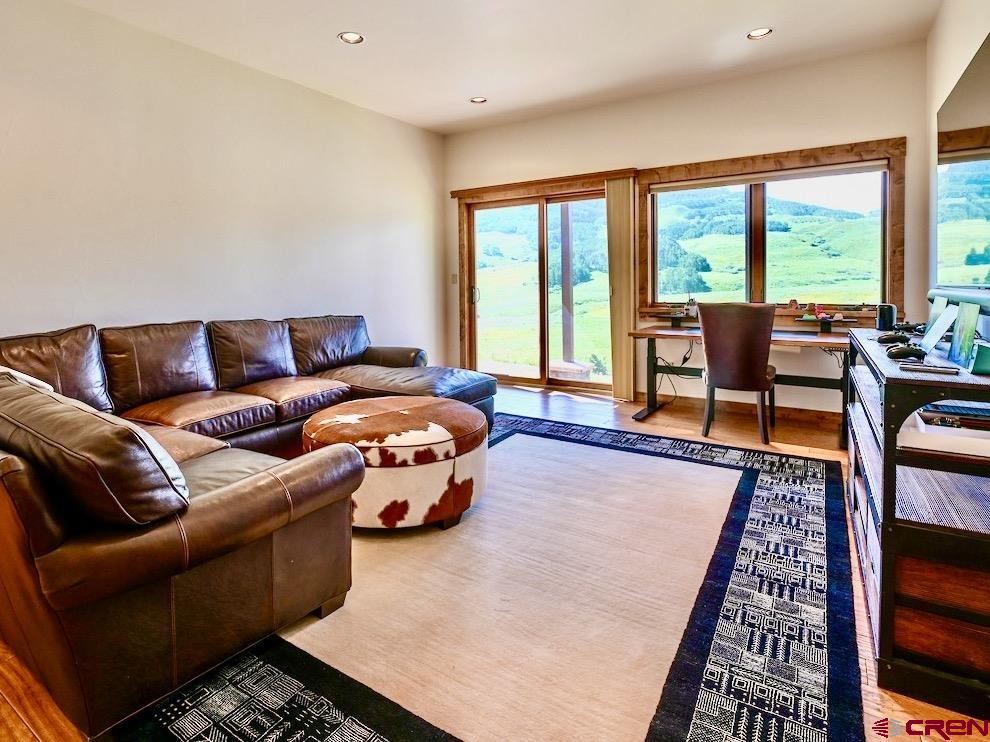 930 Gothic Road Crested Butte, CO 81225 - Photo 14 of 35 a living room with furniture and a floor to ceiling window