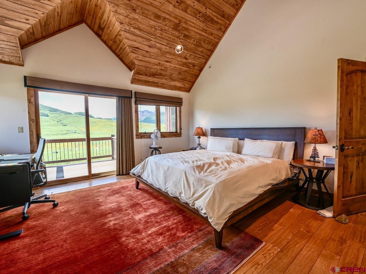 930 Gothic Road Crested Butte, CO 81225 - Photo 15 of 35 a bedroom with a bed and a large window