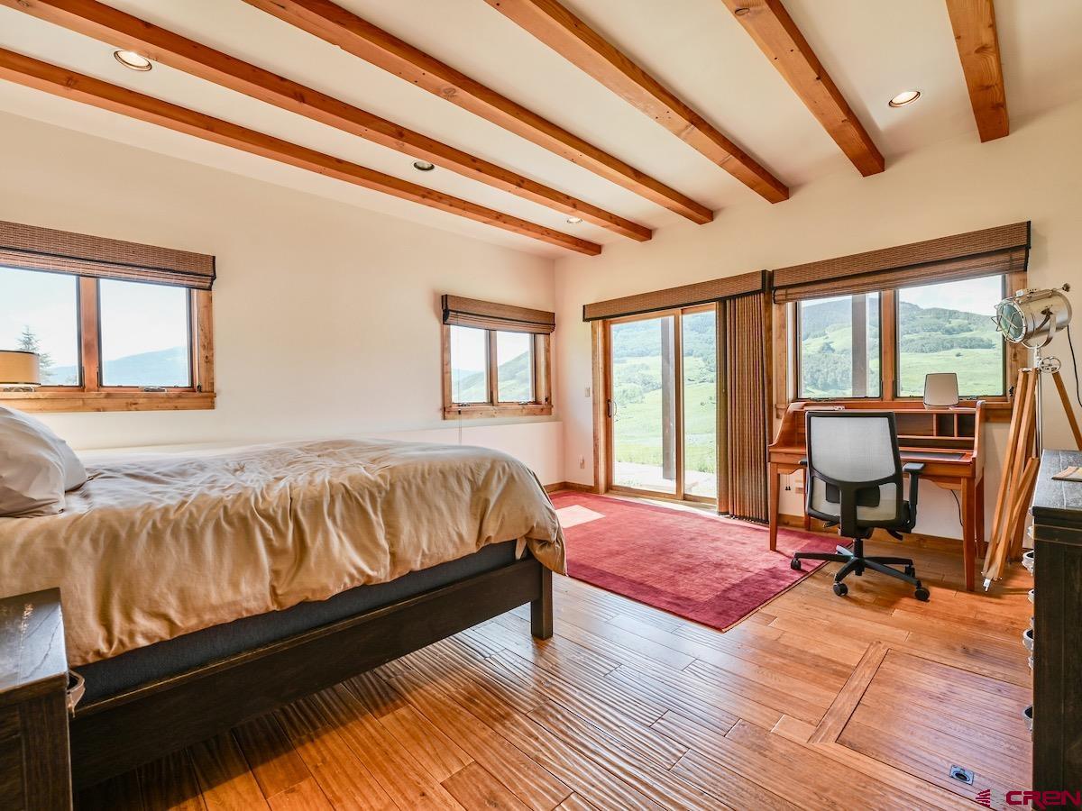 930 Gothic Road Crested Butte, CO 81225 - Photo 17 of 35 a living room with a bed furniture and a large window