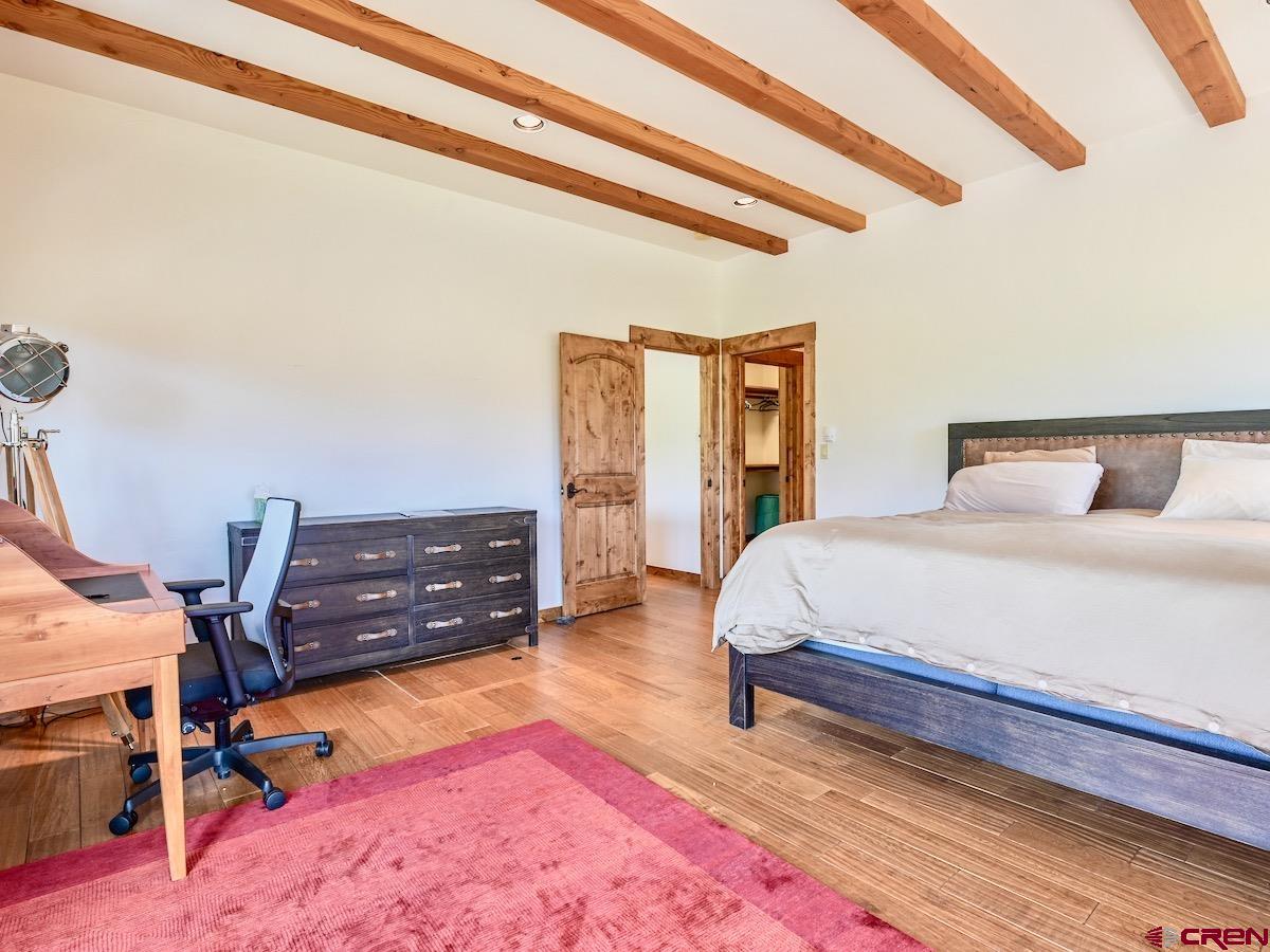 930 Gothic Road Crested Butte, CO 81225 - Photo 18 of 35 a bedroom with a bed and wooden floor