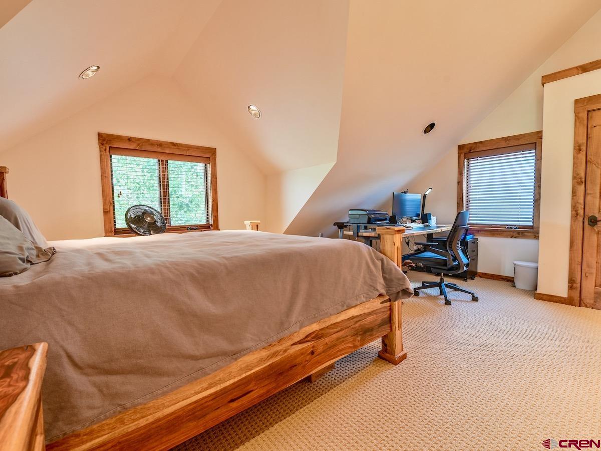 930 Gothic Road Crested Butte, CO 81225 - Photo 20 of 35 a bed room with a bed and a chair