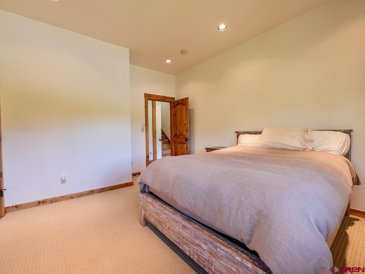 930 Gothic Road Crested Butte, CO 81225 - Photo 21 of 35 a bedroom with a bed and a night stand