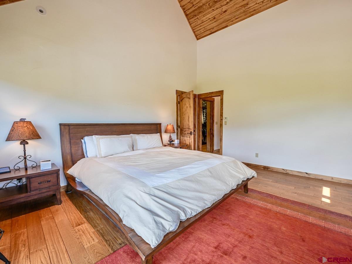 930 Gothic Road Crested Butte, CO 81225 - Photo 24 of 35 a bedroom with a bed and a lamp