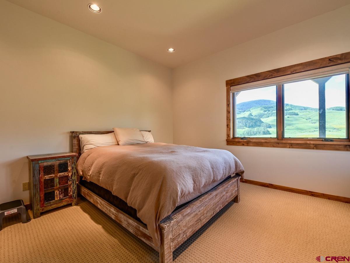 930 Gothic Road Crested Butte, CO 81225 - Photo 25 of 35 a bed sitting in a spacious bedroom next to a window