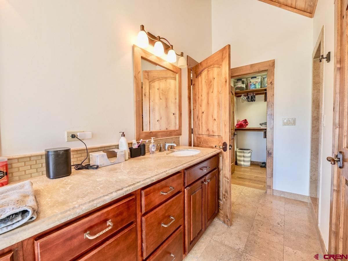 930 Gothic Road Crested Butte, CO 81225 - Photo 26 of 35 a bathroom with a granite countertop sink and a mirror