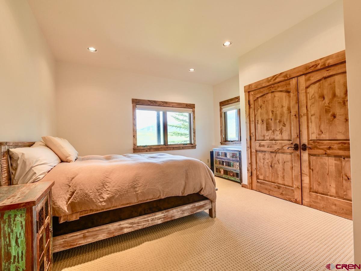 930 Gothic Road Crested Butte, CO 81225 - Photo 27 of 35 a bed room with a bed and a chair