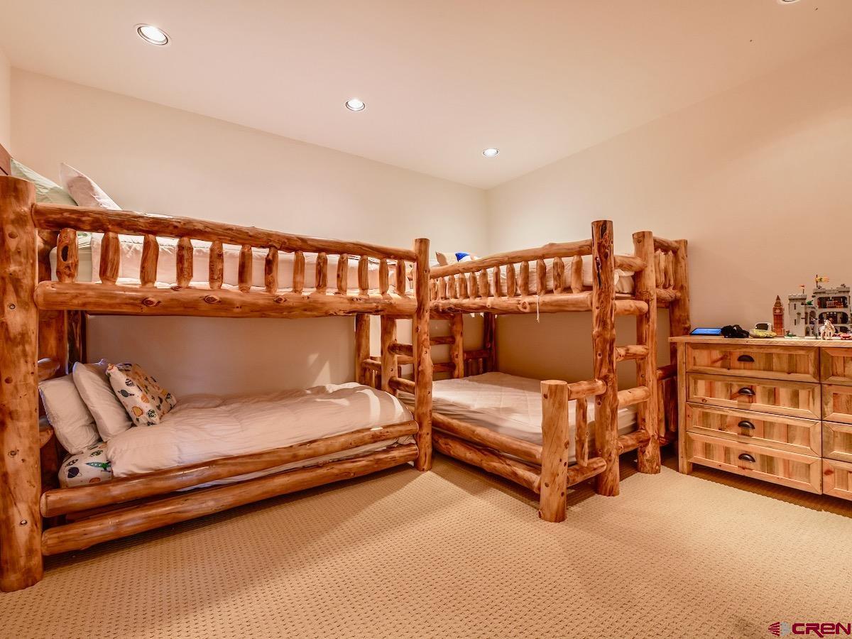 930 Gothic Road Crested Butte, CO 81225 - Photo 29 of 35 a bedroom with furniture and a book shelf