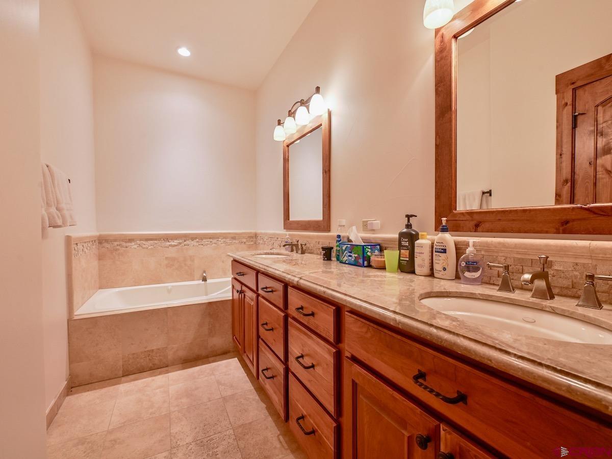 930 Gothic Road Crested Butte, CO 81225 - Photo 30 of 35 a spacious bathroom with double vanity and a bathtub