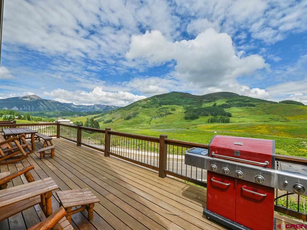 930 Gothic Road Crested Butte, CO 81225 - Photo 32 of 35 a view of a balcony with wooden floor & fence