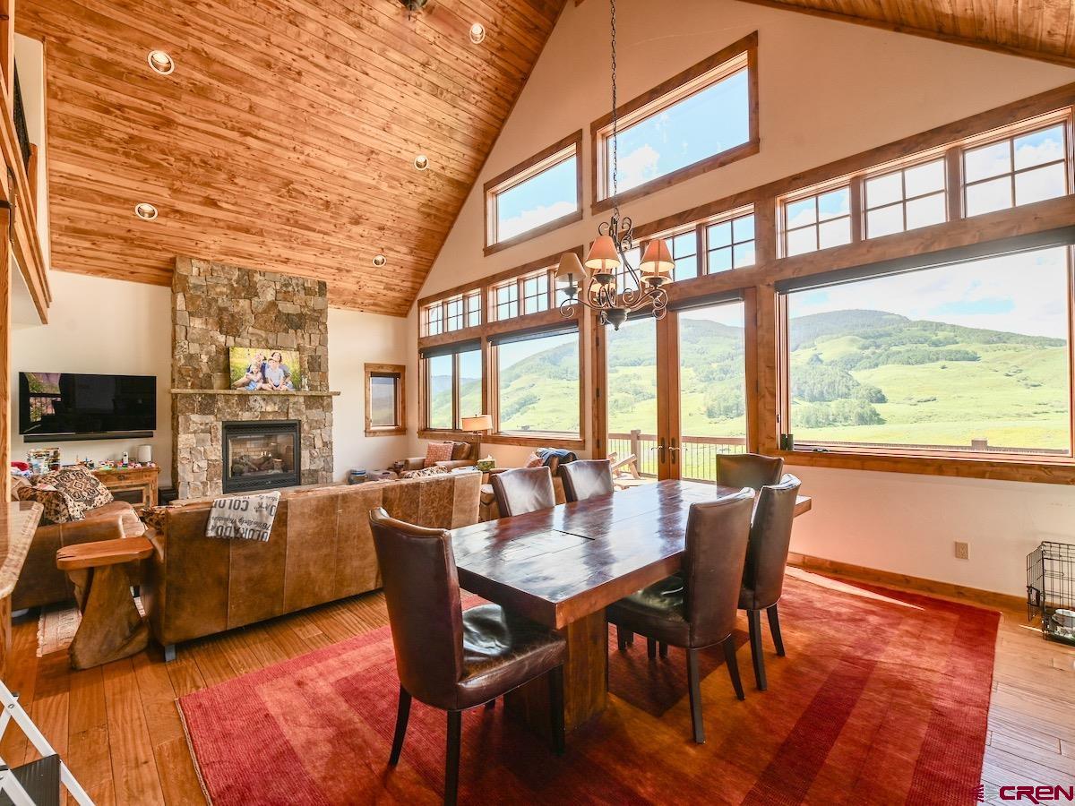 930 Gothic Road Crested Butte, CO 81225 - Photo 5 of 35 a view of a dining room with furniture window and wooden floor