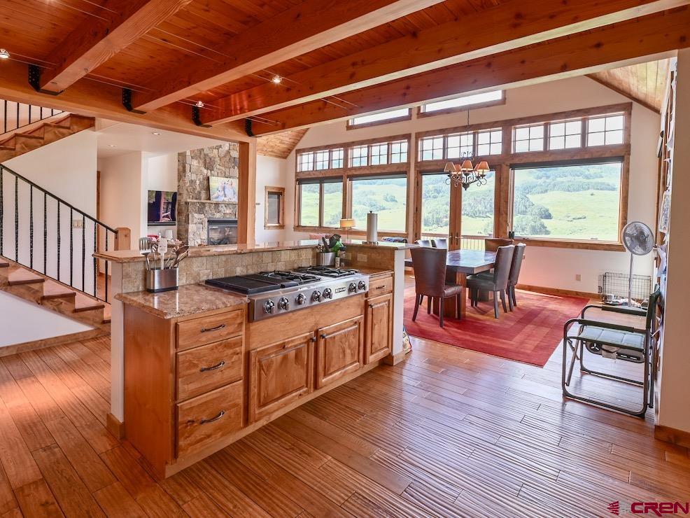 930 Gothic Road Crested Butte, CO 81225 - Photo 8 of 35 a large living room with stainless steel appliances granite countertop a stove and a wooden floors