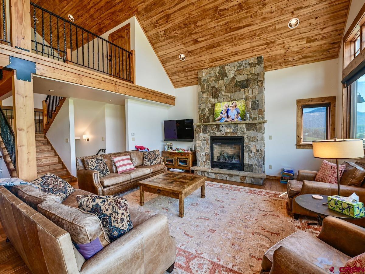 930 Gothic Road Crested Butte, CO 81225 - Photo 10 of 35 a living room with furniture a fireplace and a flat screen tv