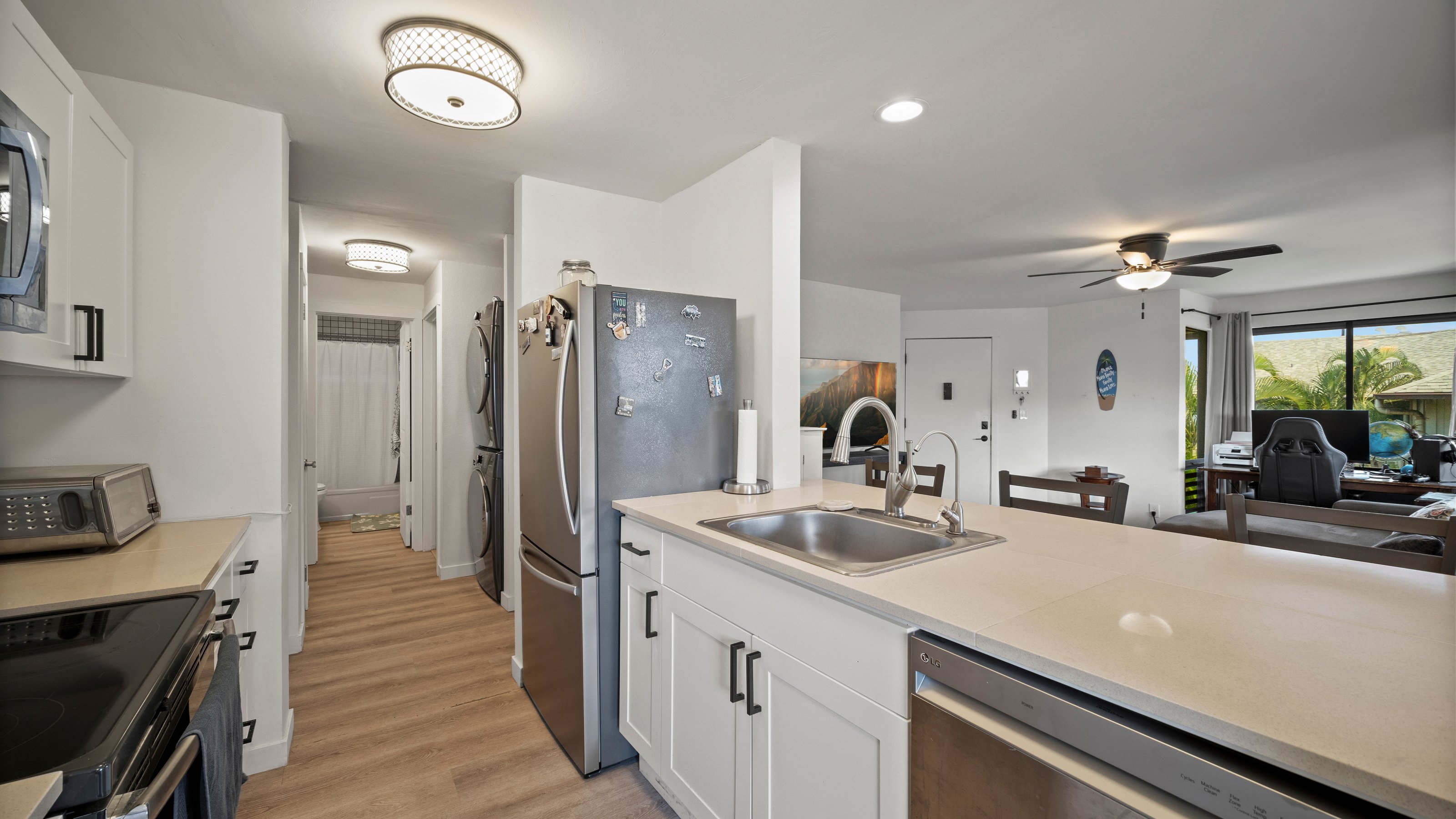 4121 Rice Street, Unit 2708 Lihue, HI 96766 - Photo 9 of 29 a kitchen with stainless steel appliances a sink stove and refrigerator