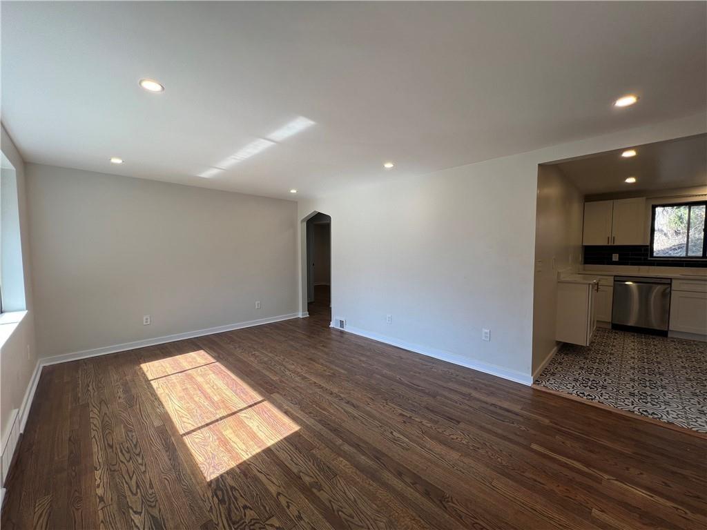 658 Fort Couch Road Pittsburgh, PA 15241 - Photo 2 of 17 a view of empty room with wooden floor and kitchen