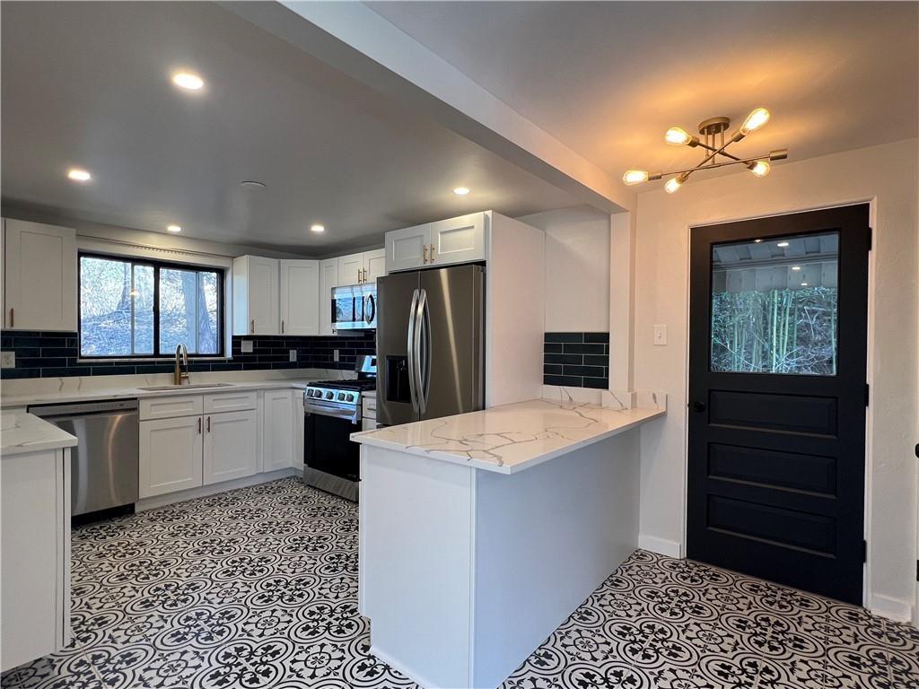 658 Fort Couch Road Pittsburgh, PA 15241 - Photo 4 of 17 a kitchen with a refrigerator and a stove top oven