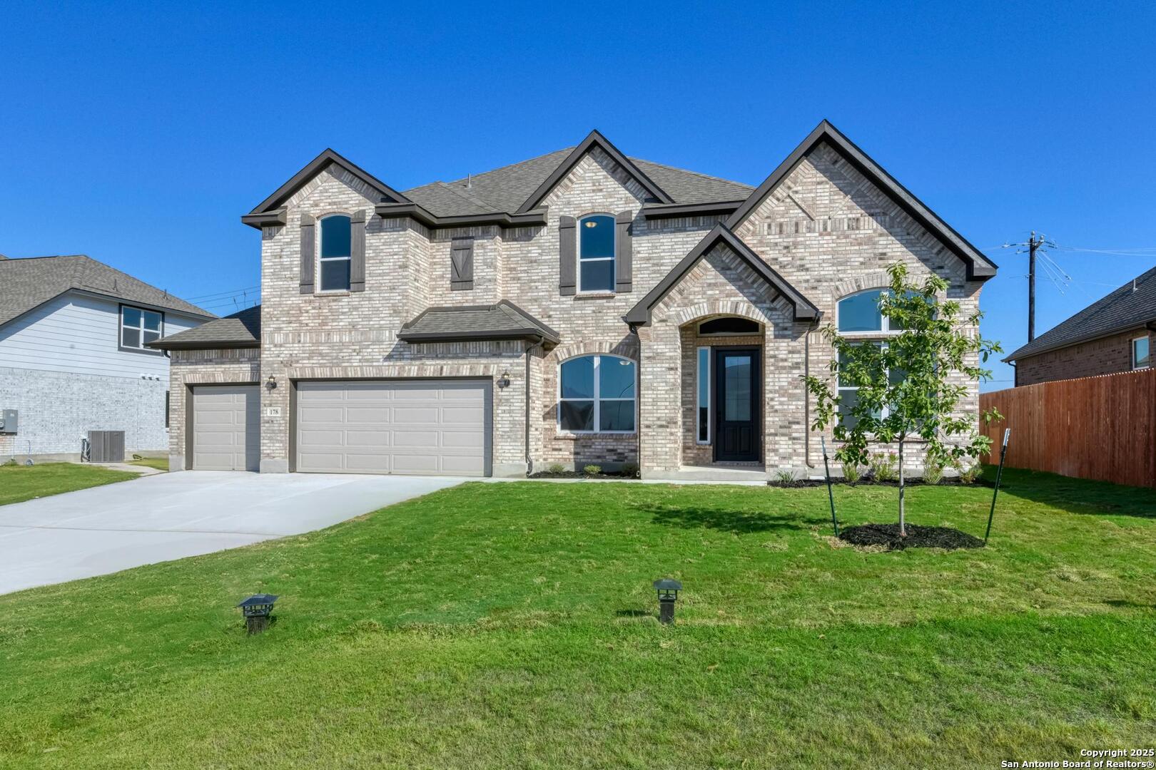 a front view of a house with a yard and garage