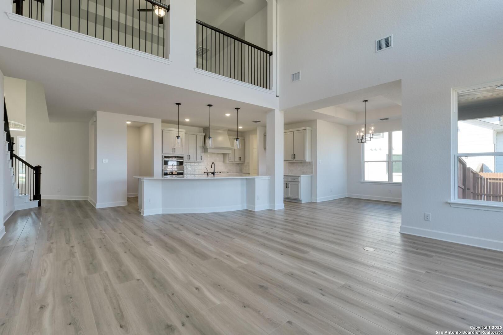 178 Annette Drive Castroville, TX 78009 - Photo 11 of 43 a view of an empty room with kitchen and window