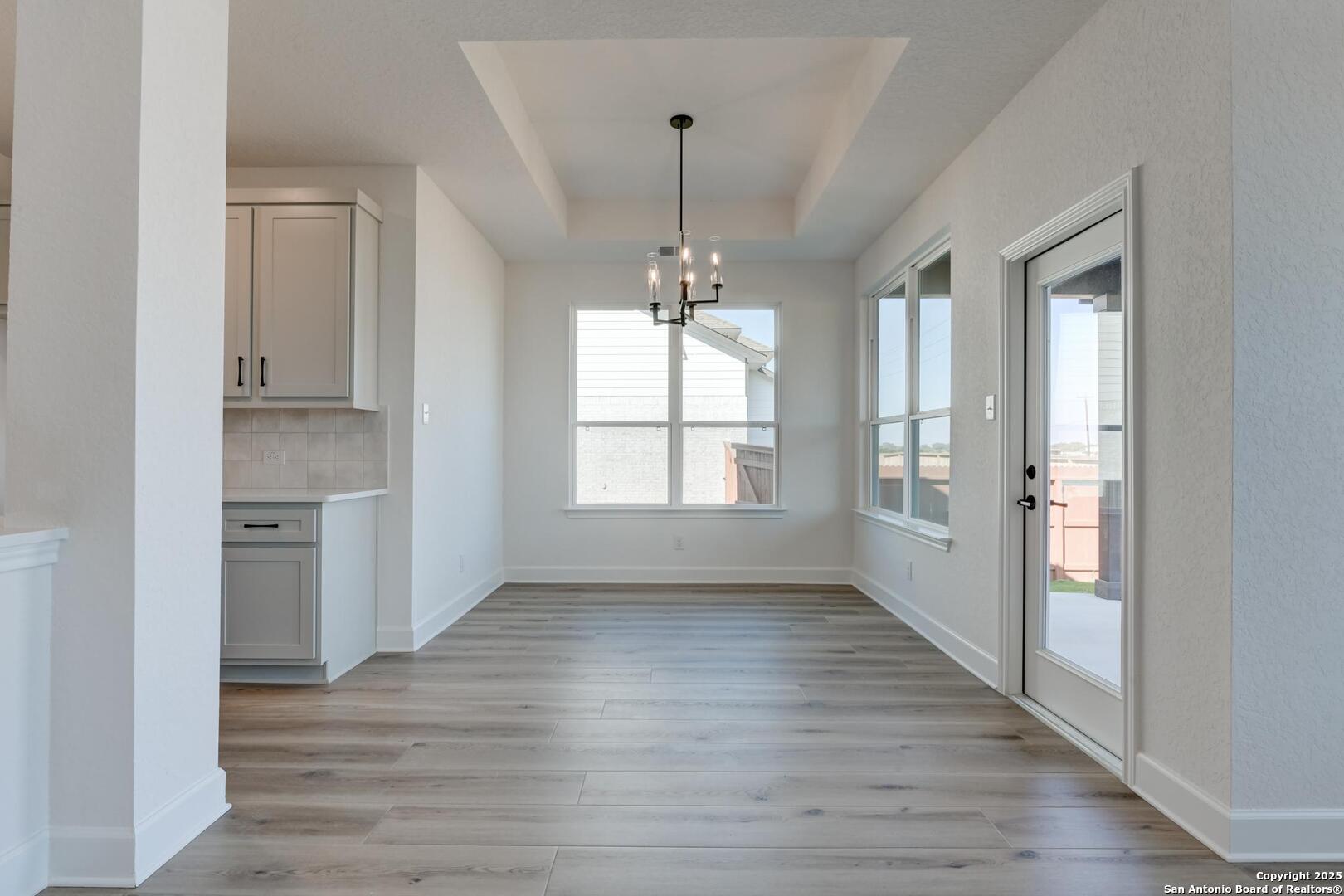 178 Annette Drive Castroville, TX 78009 - Photo 12 of 43 wooden floor in an empty room with a window