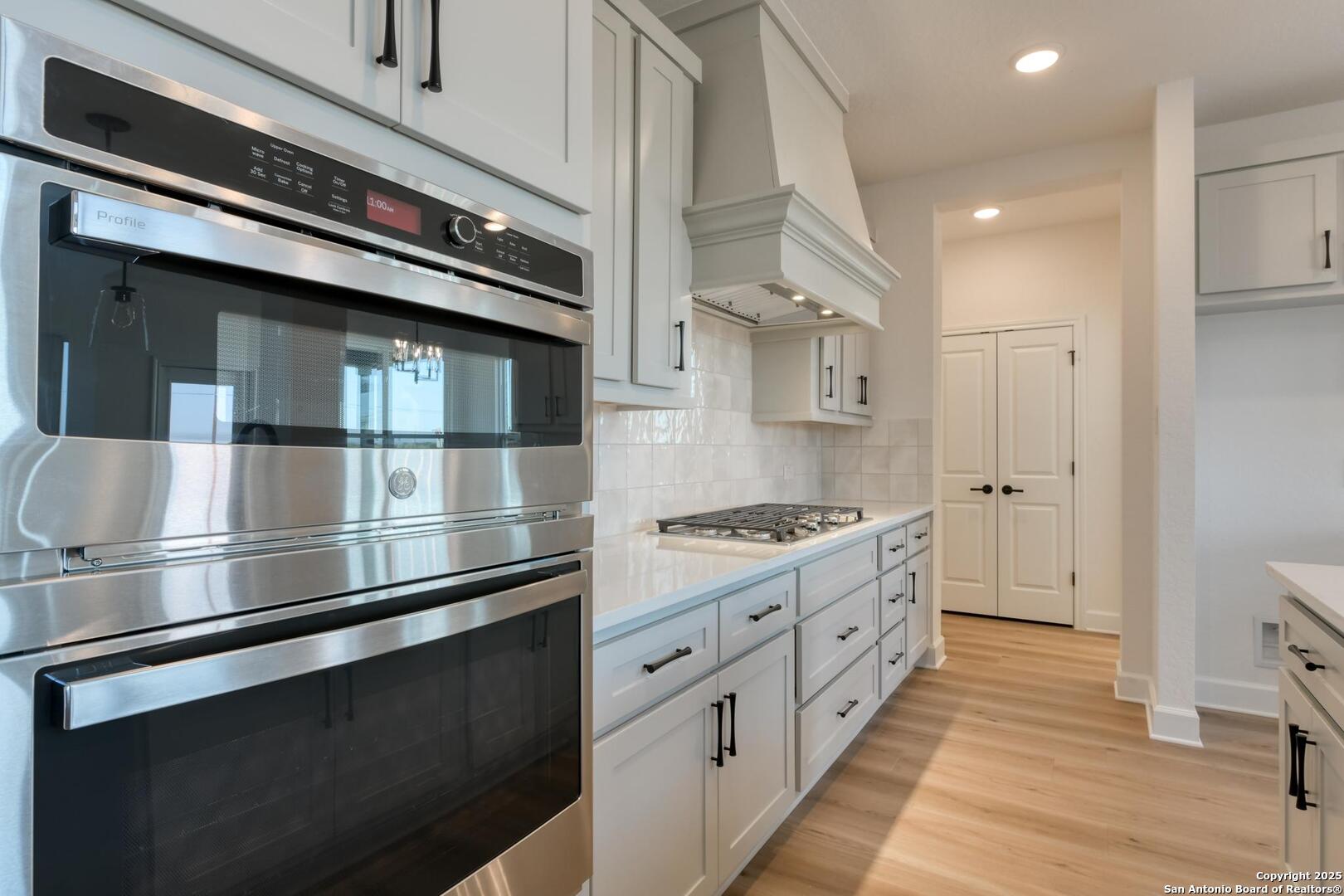 178 Annette Drive Castroville, TX 78009 - Photo 15 of 43 a kitchen with stainless steel appliances and white cabinets