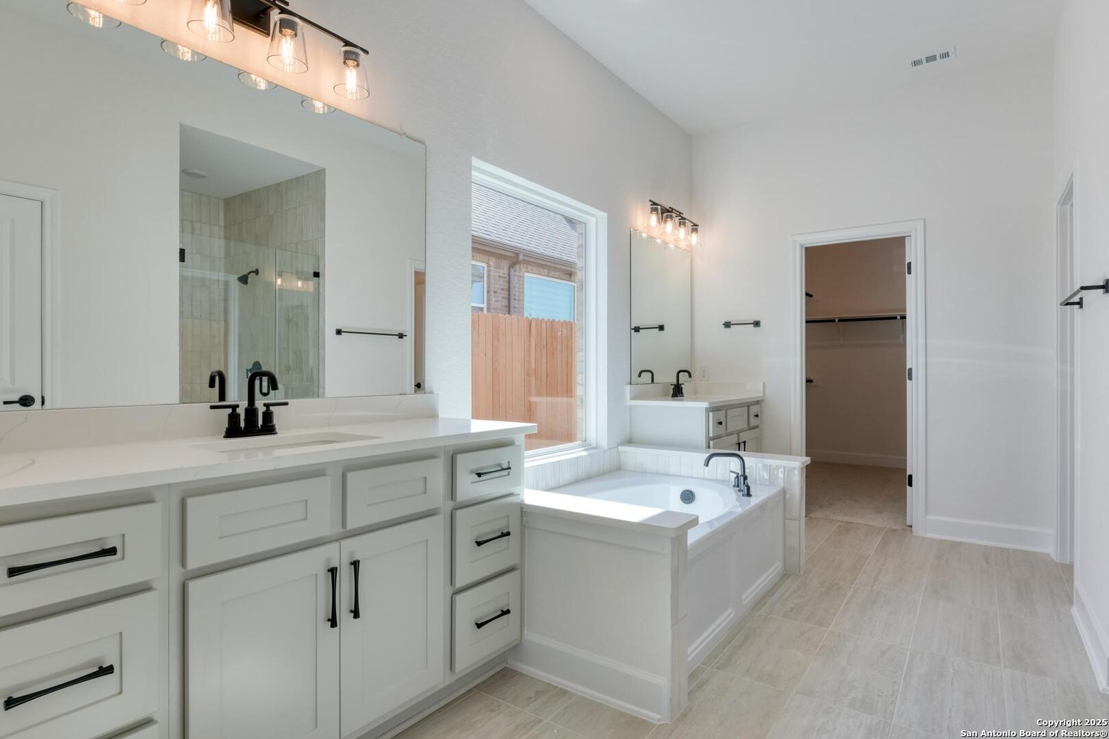 178 Annette Drive Castroville, TX 78009 - Photo 23 of 43 a spacious bathroom with a double vanity sink mirror and bathtub