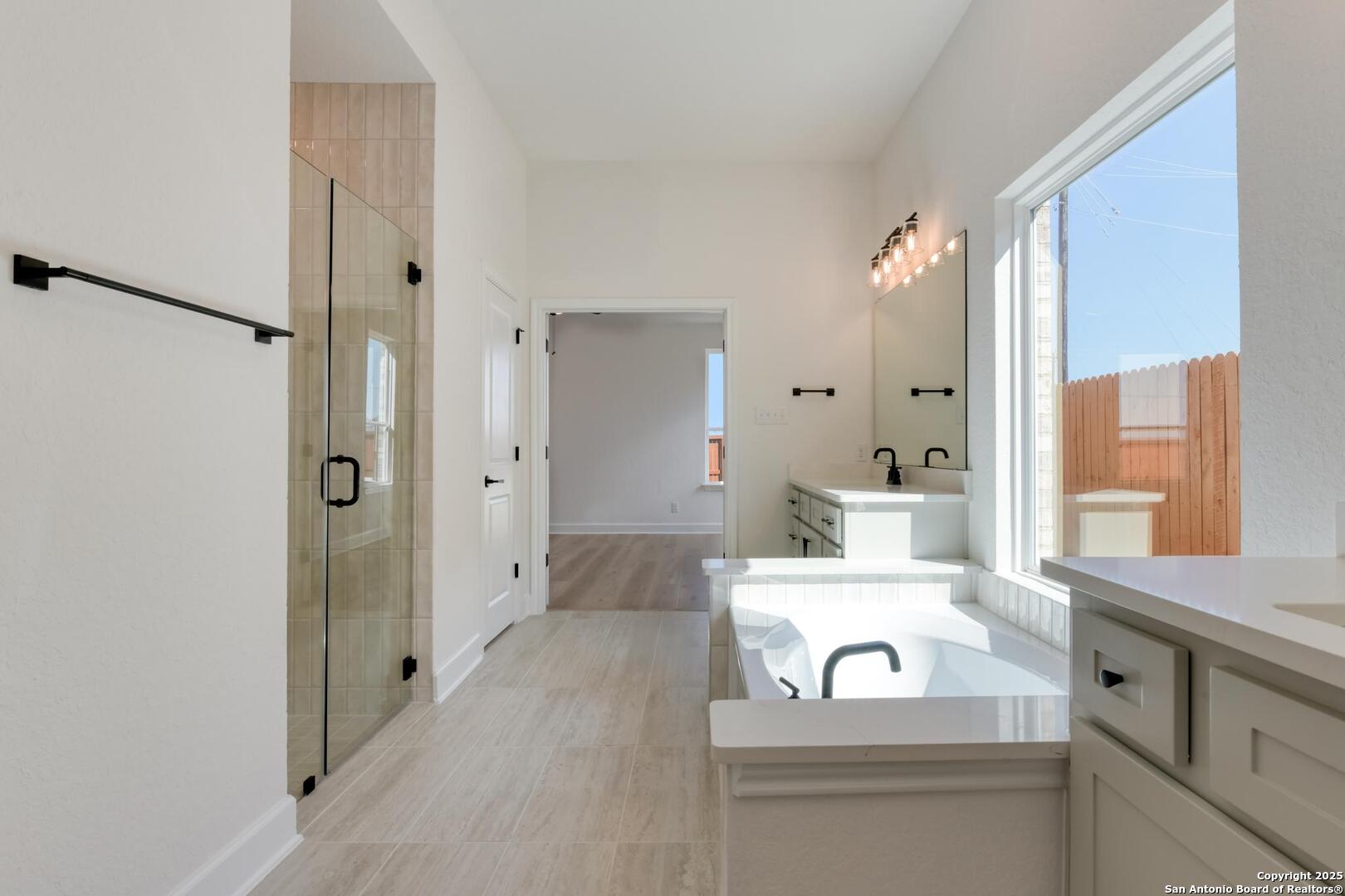 178 Annette Drive Castroville, TX 78009 - Photo 26 of 43 a bathroom with a sink a large mirror and a shower