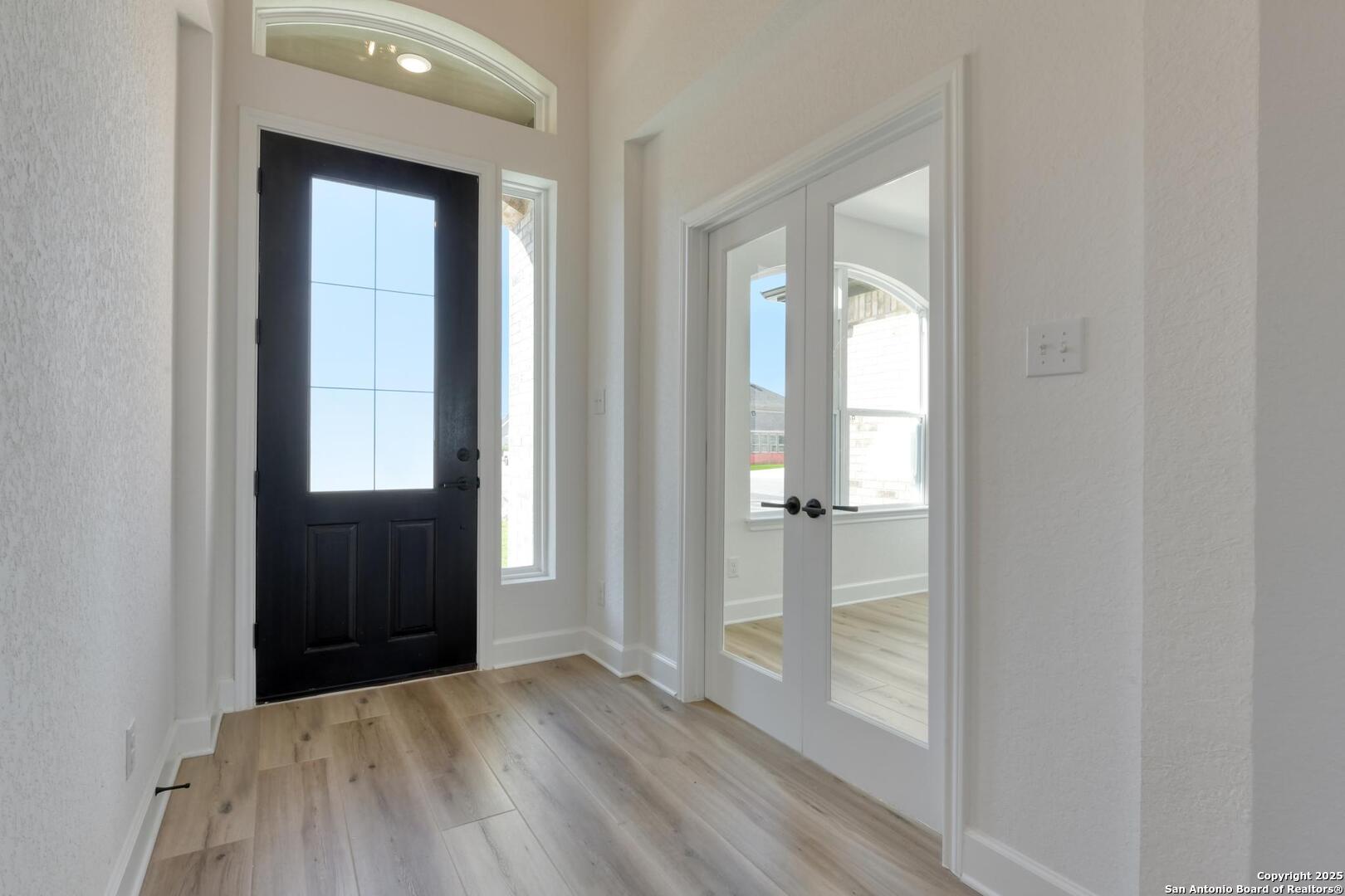 178 Annette Drive Castroville, TX 78009 - Photo 4 of 43 an empty room with wooden floor and windows