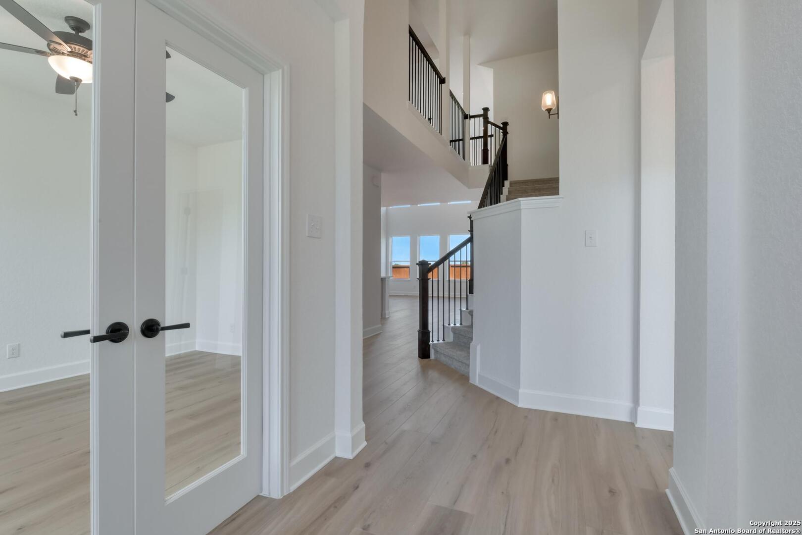 178 Annette Drive Castroville, TX 78009 - Photo 5 of 43 a view of a hallway with wooden floor and staircase