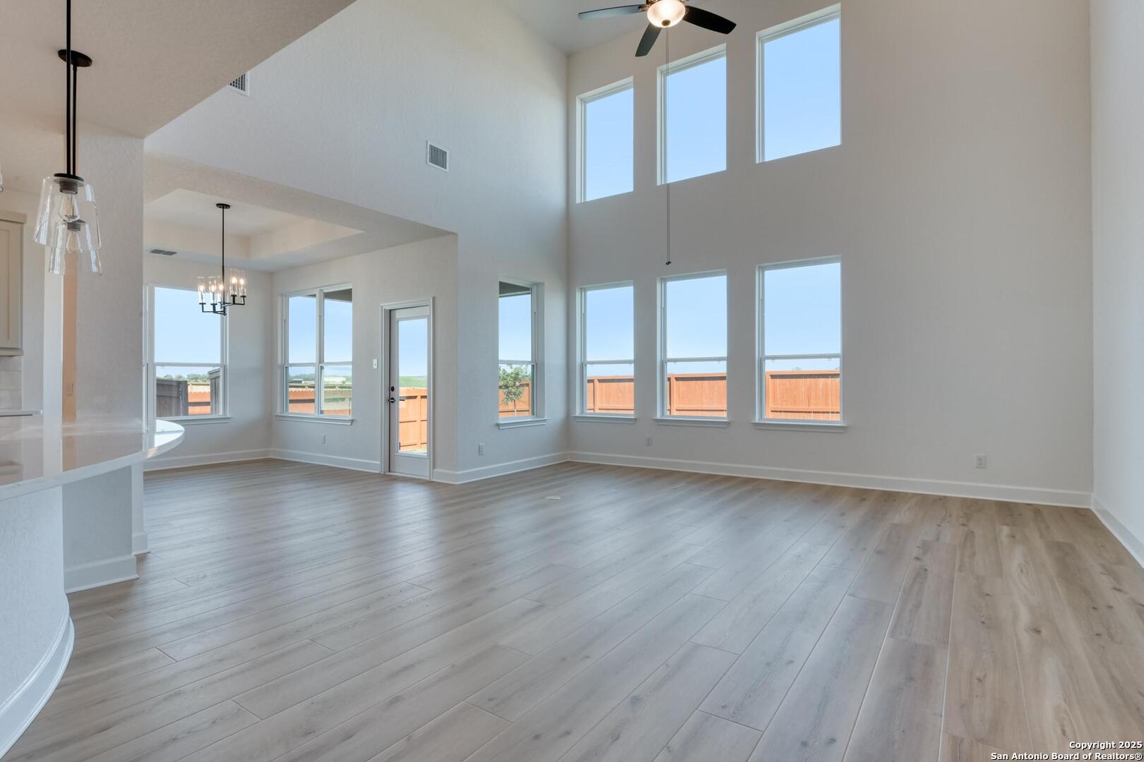 178 Annette Drive Castroville, TX 78009 - Photo 9 of 43 a view of an empty room with a window and wooden floor