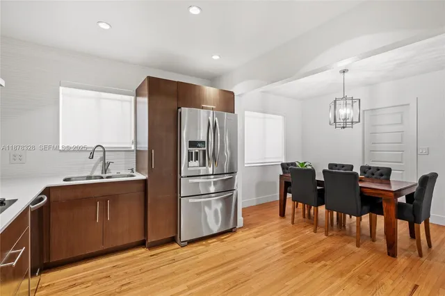 a kitchen with granite countertop cabinets stainless steel appliances and dining table