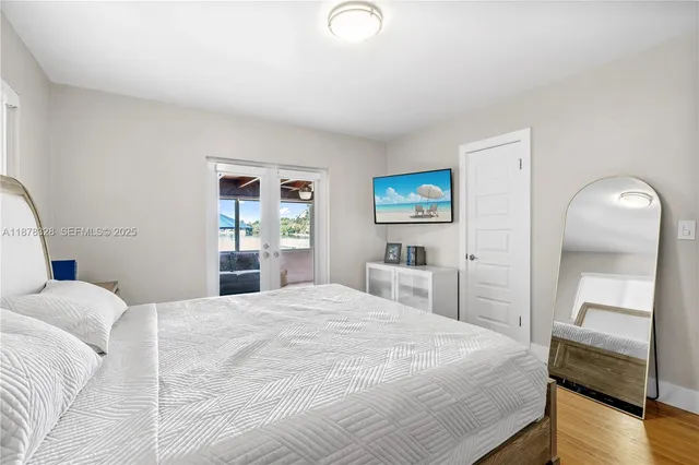 a bedroom with a bed and a television